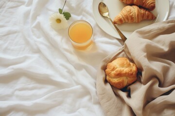 A plate of freshly baked croissants paired with a refreshing glass of orange juice. Perfect for a delicious breakfast or brunch