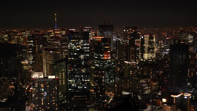 Aerial View of Japanese skycrapers from Roppongi, Tokyo, Japan at night. Scenery of central downtown area with Tokyo sky tree and business district. High quality 4k footage