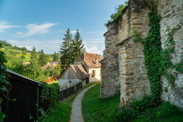Fototapeta na wymiar Path under the walls outside the Biertan fortified saxon church, Unesco World Heritage site, in Biertan village, Transylvania, Romania, Europe. Romania