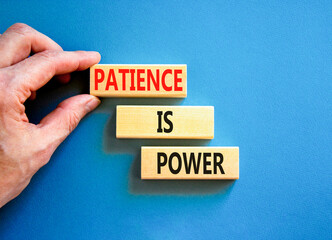 Patience is power symbol. Concept words Patience is power on beautiful wooden blocks. Beautiful blue table blue background. Businessman hand. Business and patience is power concept. Copy space.