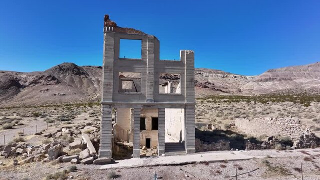 Aerial historic Cook bank Rhyolite Ghost Town Nevada front. Near Death Valley National Park in California and Beatty Nevada. 1905 gold rush, 1911 a ghost town. Ruins of banks, school, train station.