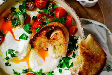 Turkish eggs. cilbir.traditional breakfast dish. selective focus. hugge style