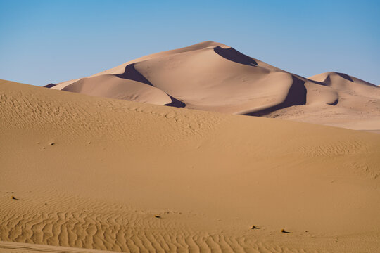 Serene Saharan dunes under clear blue skies, Erd D'Admer