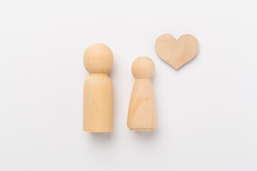 Wooden couple in love on white background, top view. Creative valentine's day composition