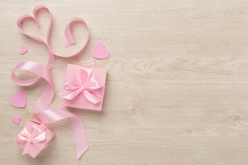 Valentines day composition with gifts on wooden background, top view.
