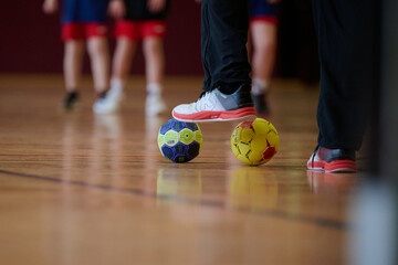 Indoor Handball Training Session Capturing Close-Up of Players' Feet and Balls