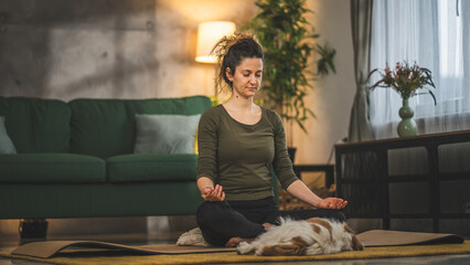 one woman doing guided meditation yoga self care practice at home