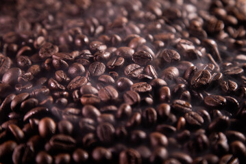 Roasted coffee beans, Coffee beans with light smoke around them. Coffee beans for the background