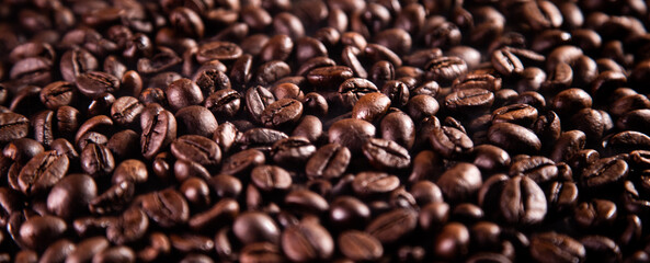 Roasted coffee beans background. Coffee beans from a perspective shot angle