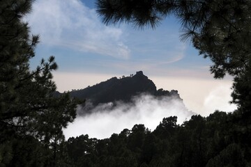Beautiful mountain scenery of National Park Caldera de Taburiente with clouds lit by sun during...