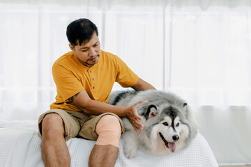 Man with dog in Livingroom at home. Pet being an inspiration while live at home. Lovely pet. Dog and man owner