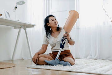 Woman hug prosthetic leg livingroom. applying leg prosthetic concept. Woman hug and checking and...