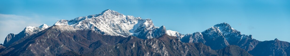 Fototapeta na wymiar Snowcaped mount Grigna and mount San Martino at lake Como, seen from Monte Crocione