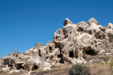 typical rock formations of Cappadocia, with sandstone rocks of volcanic origin eroded in a capricious way by water, and caves dug in them