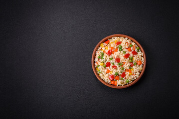 Delicious white boiled rice with vegetables, sweet peppers, carrots, peas