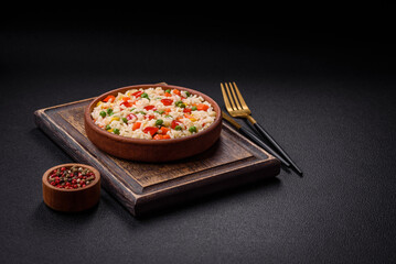 Delicious white boiled rice with vegetables, sweet peppers, carrots, peas