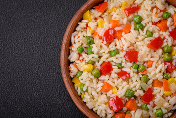 Delicious white boiled rice with vegetables, sweet peppers, carrots, peas