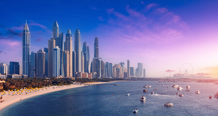 Downtown of UAE with modern futuristic skyscraper. Aerial top view Dubai, panoramic of Marina and JBR sand beaches, sunset time