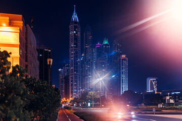 Night cityscape of center Dubai, aerial top view. Skyscrapers illuminated and highway of UAE - obrazy, fototapety, plakaty