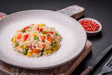 Delicious white boiled rice with vegetables, sweet peppers, carrots, peas