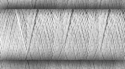 Thread roll focused on the defocused or bokeh textile thread background.
