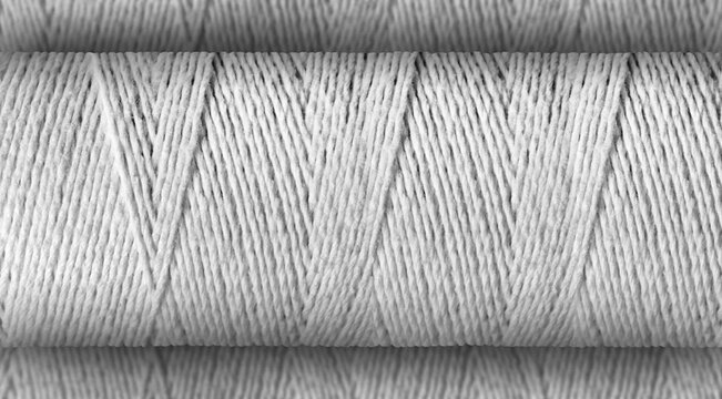 Thread roll focused on the defocused or bokeh textile thread background.