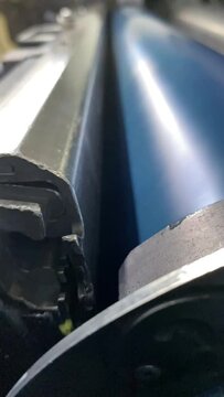 Printing. Flexographic printing machine. Anilox roller with cyan paint. Anilox. Colour printing
