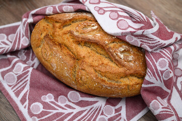 freshly baked homemade bread in a towel in the kitchen 2