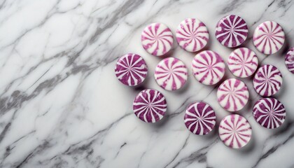 round peppermint candies on white marble surface