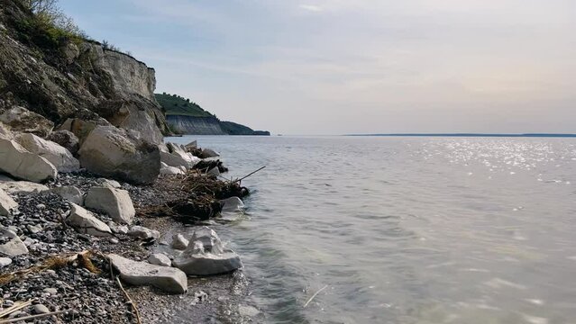 Beautiful summer view of Stepan Razin Rock on the Volga River, Saratov region, Russia. An amazing landscape with blue sky, steep cliffs and picturesque mountains with a white road. 4K