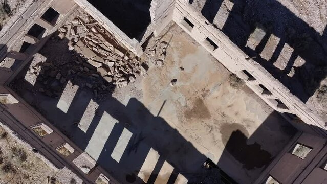 Aerial school building Rhyolite Ghost Town Nevada overhead. Near Death Valley National Park in California and Beatty Nevada. 1905 gold rush, 1911 a ghost town. Ruins of banks, school, train station.
