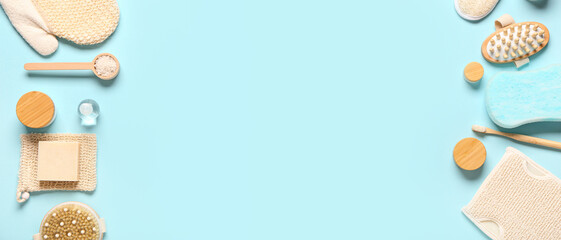 Set of bathing cosmetics and supplies on blue background with space for text