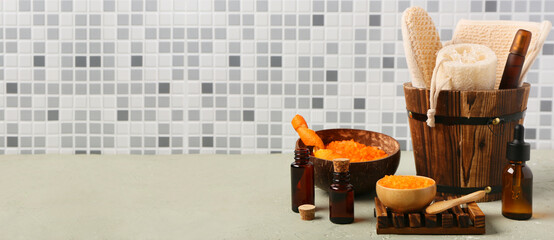 Set of bathing cosmetics and supplies on table in bathroom. Banner for design