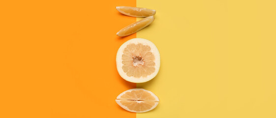 Pieces of ripe pomelo on color background, top view
