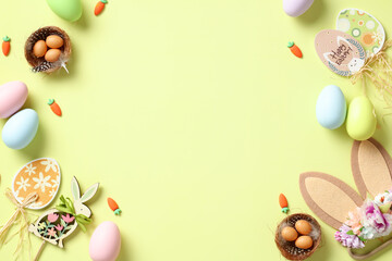 Naklejka na ściany i meble Happy Easter card. Flat lay composition with bunny ears decorated flowers, nests of eggs, wooden decorations, colorful Easter eggs on light green background