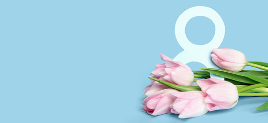 Beautiful bouquet of tulips and figure 8 on light blue background with space for text. International Women's Day celebration