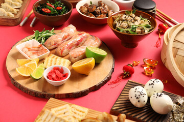 Fototapeta na wymiar Different Chinese dishes and decor on red background