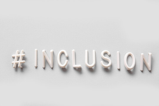 Word INCLUSION with hashtag on light background