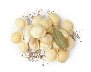 Raw dumplings with spices and bay leaf on white background