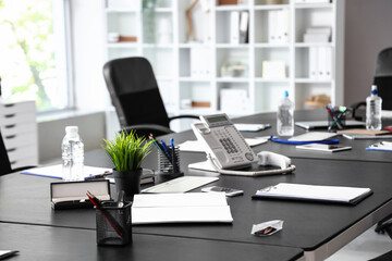 Desk with office stationery in conference room, closeup