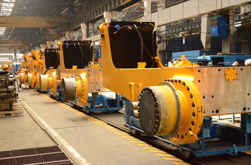Crawler bulldozer assembly line. Spare parts for assembly on the production line. Heavy industry. Construction equipment.