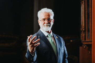 Experienced university rector confidently posing and gestures with arm, embodying the essence of...