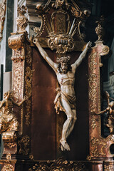 Wooden crucifix with Jesus Christ in the Jesuit church in Lviv, Ukraine. Christmas Eve and Easter.