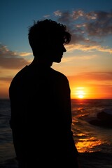 Fototapeta premium side portrait of young handsome man at sunset, face of guy in silhouette