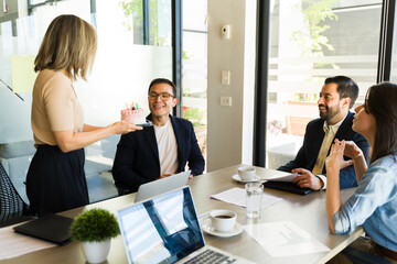 Woman bringing a birthday cake for a businessman in a meeting room