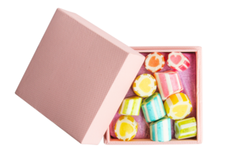 pink box with sweets and lollipops on an empty background.