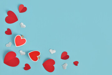 Frame made of paper hearts on blue background