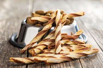Dog food. Snack sticks for dogs on wooden table.