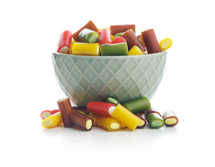 Sweet colorful chewy candy sticks in bowl  isolated on white background.