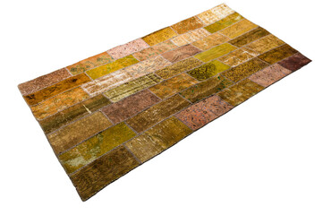 Handmade modern patchwork rug with tones of yellow, beige and brown isolated on white